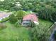 Aerial view of a home showcasing the red tile roof, screened pool, lush landscaping, and manicured lawn at 10504 Echo Lake Dr, Odessa, FL 33556