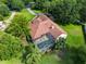 Stunning aerial view of the home with a private screened-in pool surrounded by lush landscaping at 10504 Echo Lake Dr, Odessa, FL 33556