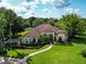 Beautifully landscaped property with a red tile roof and inviting curb appeal at 10504 Echo Lake Dr, Odessa, FL 33556