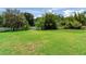 Spacious backyard, bordered by lush trees and a fence for privacy at 10504 Echo Lake Dr, Odessa, FL 33556
