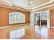 Spacious bedroom featuring hardwood floors, a tray ceiling, and access to a screened patio at 10504 Echo Lake Dr, Odessa, FL 33556