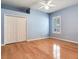 Bedroom with hardwood floors, large window with plantation shutters and large closet at 10504 Echo Lake Dr, Odessa, FL 33556