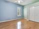 Bedroom featuring hardwood floors, closet and large window with plantation shutters at 10504 Echo Lake Dr, Odessa, FL 33556