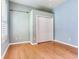 Bedroom featuring hardwood floors, closet and large window with plantation shutters at 10504 Echo Lake Dr, Odessa, FL 33556