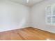 Bright bedroom features hardwood floors, neutral paint and large window with plantation shutters at 10504 Echo Lake Dr, Odessa, FL 33556