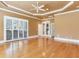 Spacious bedroom features hardwood floors, neutral paint, tray ceiling, and modern ceiling fan at 10504 Echo Lake Dr, Odessa, FL 33556