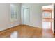 Bright bedroom with hardwood floors, a closet, and a view into an adjoining room at 10504 Echo Lake Dr, Odessa, FL 33556