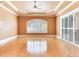 Spacious bedroom featuring hardwood floors, a tray ceiling, and access to a screened patio at 10504 Echo Lake Dr, Odessa, FL 33556