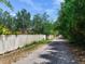 Long driveway bordered by a white fence and mature trees at 10504 Echo Lake Dr, Odessa, FL 33556