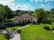 A charming single-story home with a tile roof, lush green lawn and a winding brick driveway at 10504 Echo Lake Dr, Odessa, FL 33556