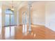 Bright foyer with hardwood floors, decorative columns, and arched doorways at 10504 Echo Lake Dr, Odessa, FL 33556