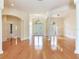 Open foyer with hardwood floors, decorative columns, and access to multiple rooms at 10504 Echo Lake Dr, Odessa, FL 33556