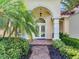 Inviting entrance with double doors, brick walkway, and vibrant landscaping at 10504 Echo Lake Dr, Odessa, FL 33556