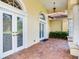 Charming entrance with double doors, tile flooring, and lush landscaping at 10504 Echo Lake Dr, Odessa, FL 33556