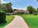 Charming home with a tile roof, a curved brick driveway, and manicured landscaping at 10504 Echo Lake Dr, Odessa, FL 33556