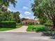 Charming single-story home featuring a brick driveway, well-manicured lawn, and lush landscaping at 10504 Echo Lake Dr, Odessa, FL 33556