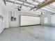 Spacious garage with epoxy flooring, custom cabinets for storage, and natural light from the windows at 10504 Echo Lake Dr, Odessa, FL 33556