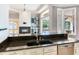 Well-appointed kitchen features granite counters, stainless appliances, and an open design with fireplace views at 10504 Echo Lake Dr, Odessa, FL 33556