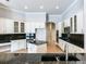 Expansive kitchen with granite countertops, white cabinets, stainless appliances, and a center island at 10504 Echo Lake Dr, Odessa, FL 33556