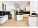 Modern kitchen featuring stainless steel appliances and an island at 10504 Echo Lake Dr, Odessa, FL 33556