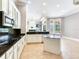 Modern kitchen with white cabinetry, black granite countertops, and a functional center island at 10504 Echo Lake Dr, Odessa, FL 33556
