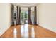 Bright living room featuring hardwood floors, bay windows, and access to outdoor space at 10504 Echo Lake Dr, Odessa, FL 33556