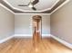 Living room featuring hardwood floors, neutral walls, tray ceilings, and arched doorway at 10504 Echo Lake Dr, Odessa, FL 33556