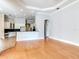Open-concept living area with hardwood floors that transitions to a kitchen area with white cabinetry at 10504 Echo Lake Dr, Odessa, FL 33556