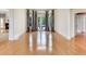 Spacious living room features hardwood floors, large windows, and access to the outdoors at 10504 Echo Lake Dr, Odessa, FL 33556
