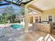 Stunning outdoor entertaining space with pool, spa, and outdoor kitchen under a screened lanai at 10504 Echo Lake Dr, Odessa, FL 33556