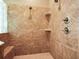Shower with tile walls and built-in shelves at 10504 Echo Lake Dr, Odessa, FL 33556