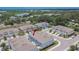 Aerial view of residential community with well-maintained townhomes, landscaping, and nearby lake at 10907 Golden Acorn Ave, Tampa, FL 33610