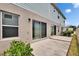 Backyard patio with sliding glass doors, and some landscaping in the community at 10907 Golden Acorn Ave, Tampa, FL 33610