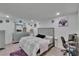 Well-lit bedroom with a decorative mirror, comfortable bed, and convenient workspace at 10907 Golden Acorn Ave, Tampa, FL 33610