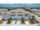 Exterior shot of modern townhomes with attached garages and colorful blue accents at 10907 Golden Acorn Ave, Tampa, FL 33610