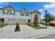Inviting townhome featuring a front-entry garage, landscaped yard, and a well-maintained lawn at 10907 Golden Acorn Ave, Tampa, FL 33610