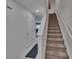 Hallway with tile floors and staircase leading to the next level, complemented by fresh paint at 10907 Golden Acorn Ave, Tampa, FL 33610