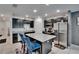 Modern kitchen with stainless steel appliances, black cabinets, granite counters and an island with seating at 10907 Golden Acorn Ave, Tampa, FL 33610