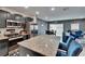 Open-concept living space with kitchen featuring granite island and stainless appliances and cozy blue furniture at 10907 Golden Acorn Ave, Tampa, FL 33610