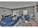 Inviting living room featuring stylish blue furniture, decor, and ample natural light for a comfortable living space at 10907 Golden Acorn Ave, Tampa, FL 33610