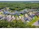 A high-angle showcases a lovely residential community with a pond, green spaces and well-maintained homes at 11510 Quiet Forest Dr, Tampa, FL 33635