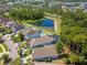 An aerial view showing well-maintained homes, a pond, and lush landscaping in a desirable community at 11510 Quiet Forest Dr, Tampa, FL 33635