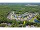 Aerial view features beautiful houses with private pools situated around ponds surrounded by lush, mature green forest at 11510 Quiet Forest Dr, Tampa, FL 33635