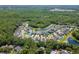 Aerial view features beautiful houses with private pools situated around ponds surrounded by lush, mature green forest at 11510 Quiet Forest Dr, Tampa, FL 33635