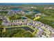 Aerial view of a lovely neighborhood with community lakes and lush greenery; view of the home at 11510 Quiet Forest Dr, Tampa, FL 33635