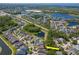 An aerial view shows beautiful homes near ponds surrounded by lush greenery and modern residential developments at 11510 Quiet Forest Dr, Tampa, FL 33635