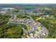 Aerial view of a lovely neighborhood with community lakes and lush greenery; view of the home at 11510 Quiet Forest Dr, Tampa, FL 33635