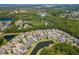 Aerial view features beautiful houses with private pools situated around ponds surrounded by lush, mature green forest at 11510 Quiet Forest Dr, Tampa, FL 33635