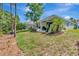 Beautiful backyard with a covered patio and ample green space at 11510 Quiet Forest Dr, Tampa, FL 33635