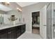 Bathroom featuring a double vanity, granite countertop, with view of a bedroom at 11510 Quiet Forest Dr, Tampa, FL 33635